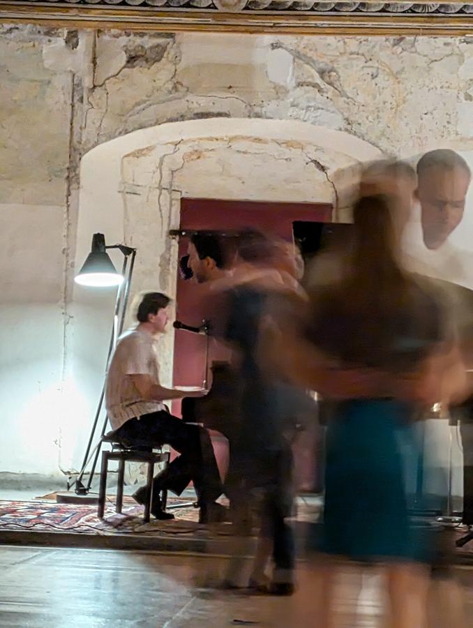 Couples dancing blues in the palace ballroom to live piano, long exposure